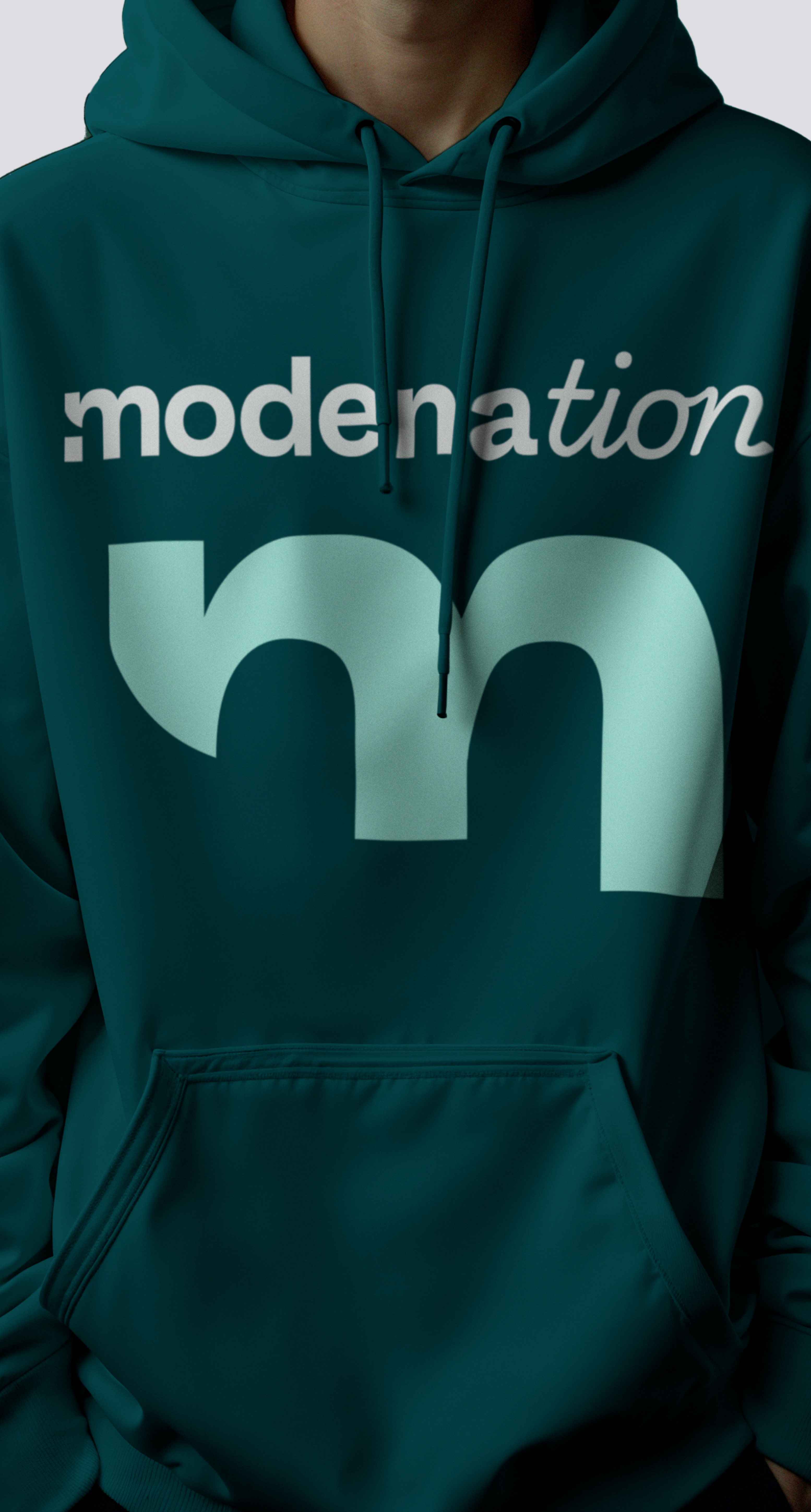Person wearing a teal Modena hoodie with the 'modenation' wordmark and large m monogram