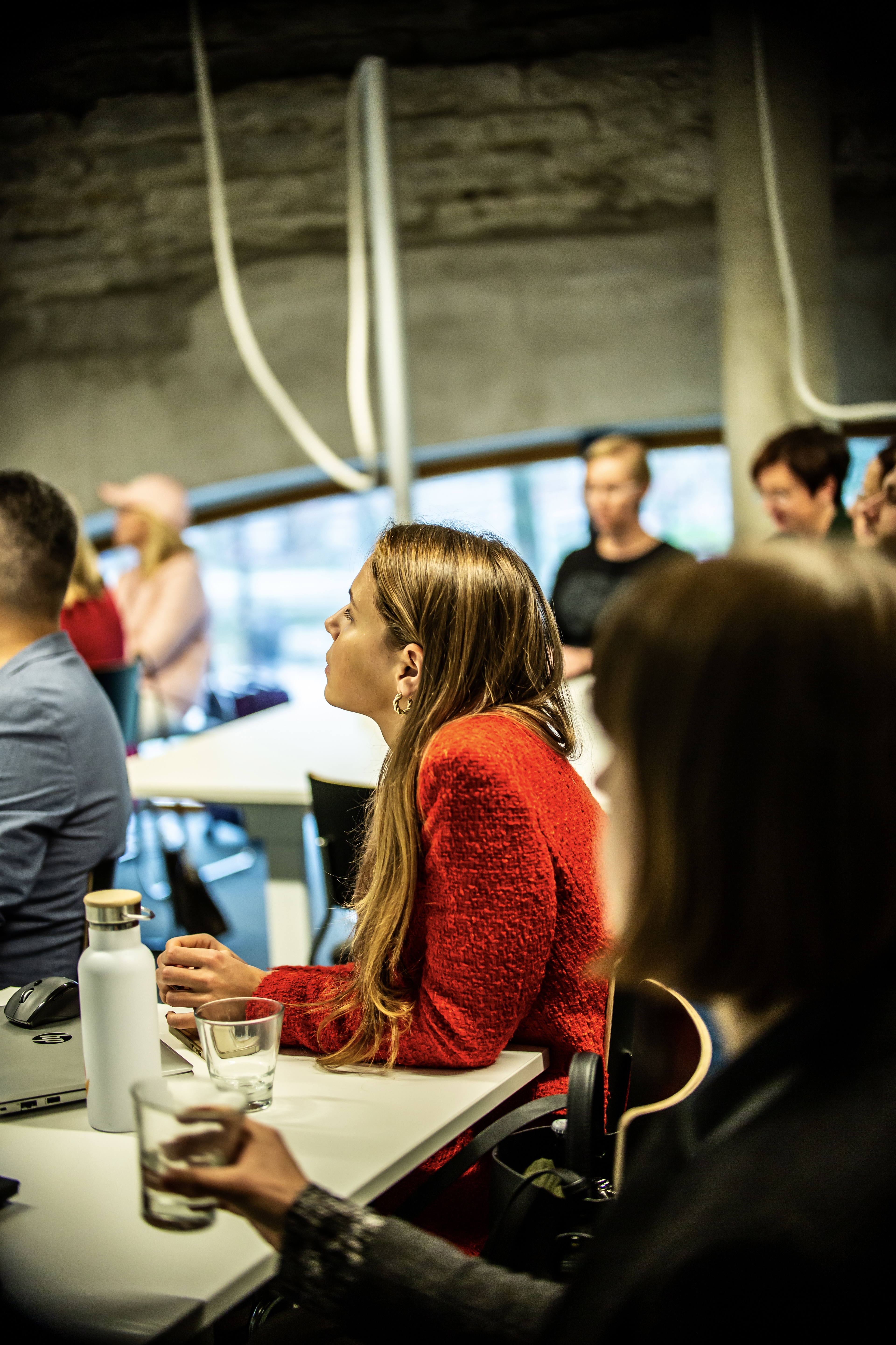 A participant listening during an Omniva service design academy session