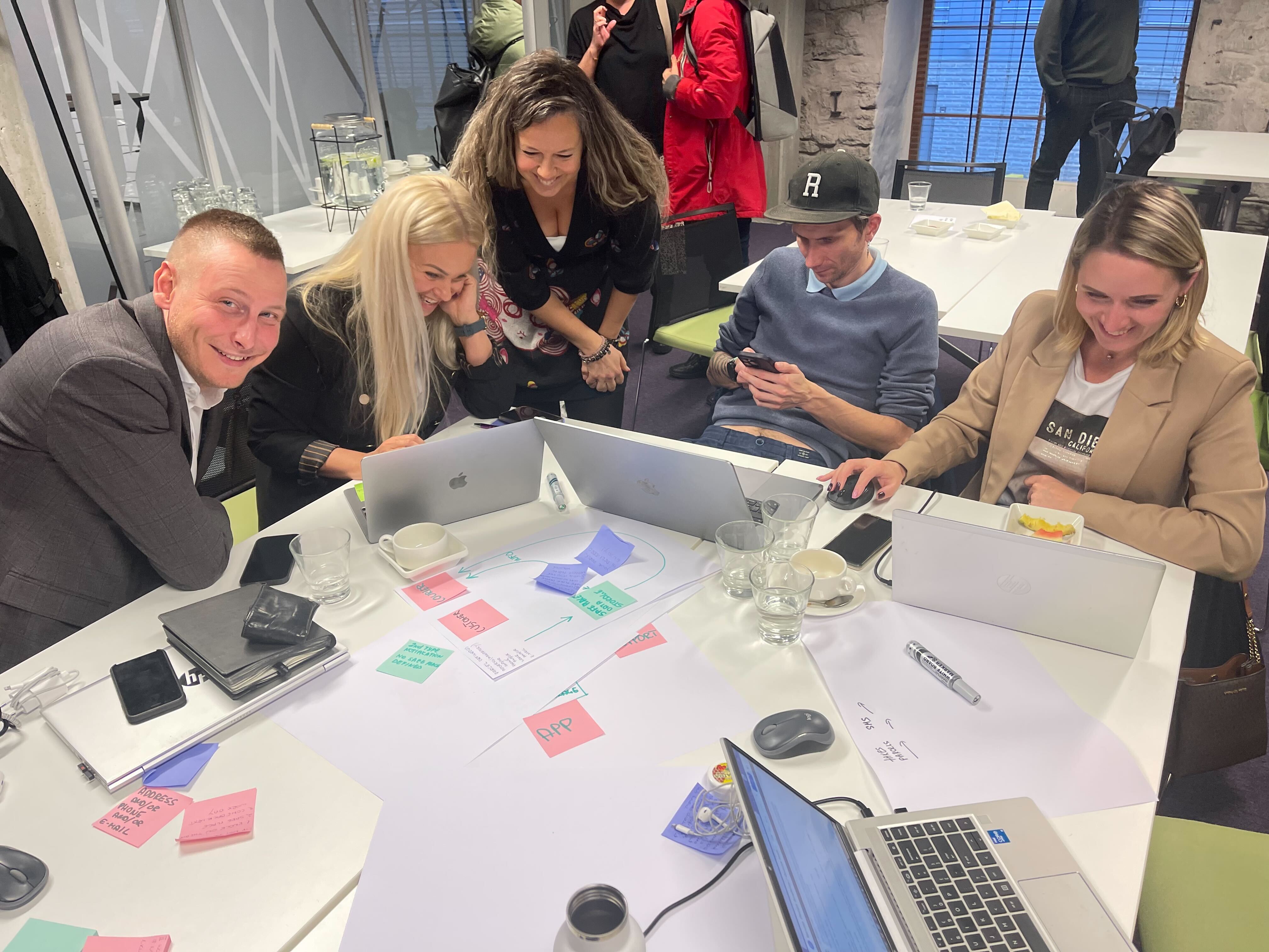 A team working with sticky notes during an Omniva service design exercise