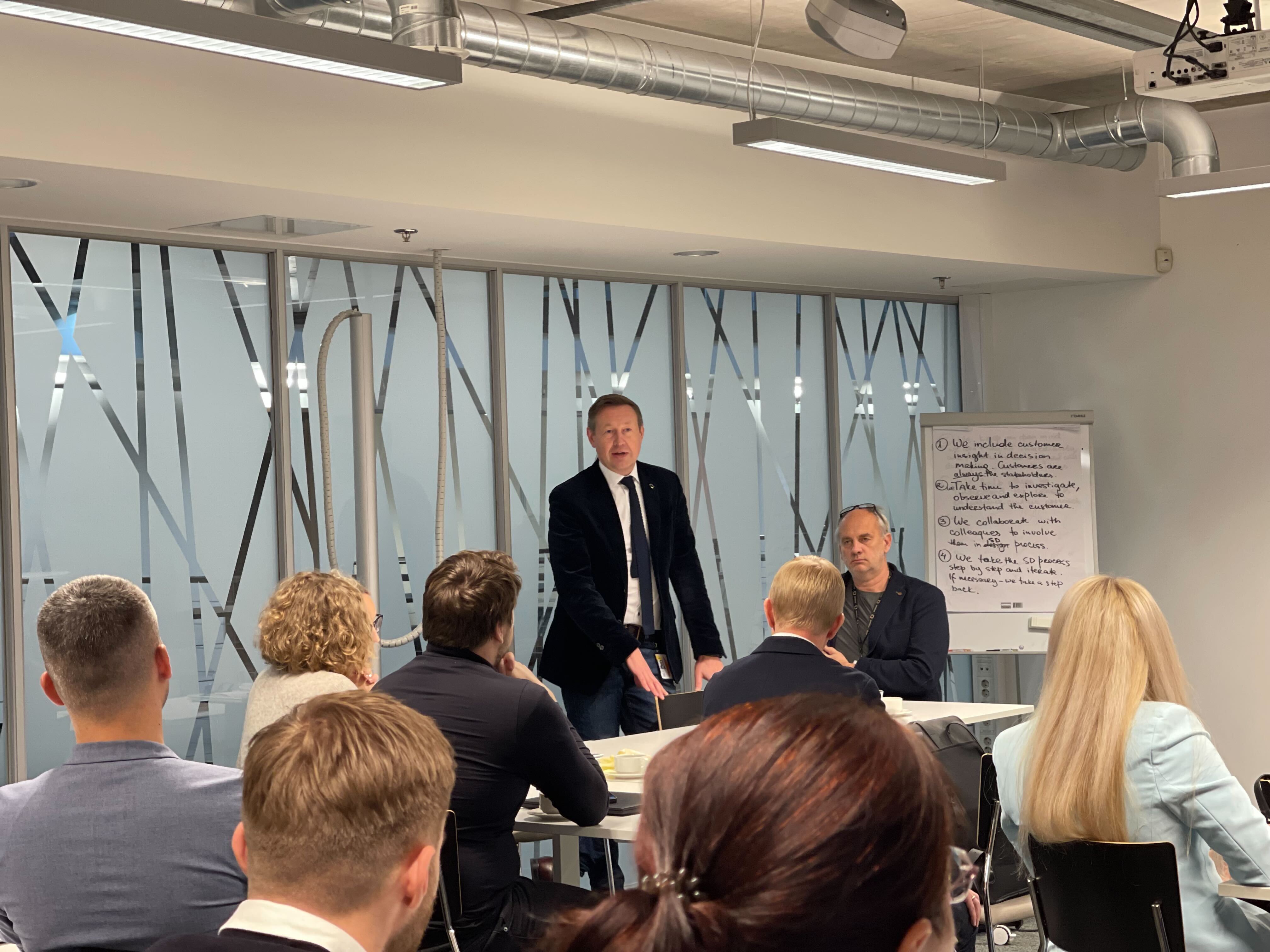 A leader addressing participants during an Omniva academy session