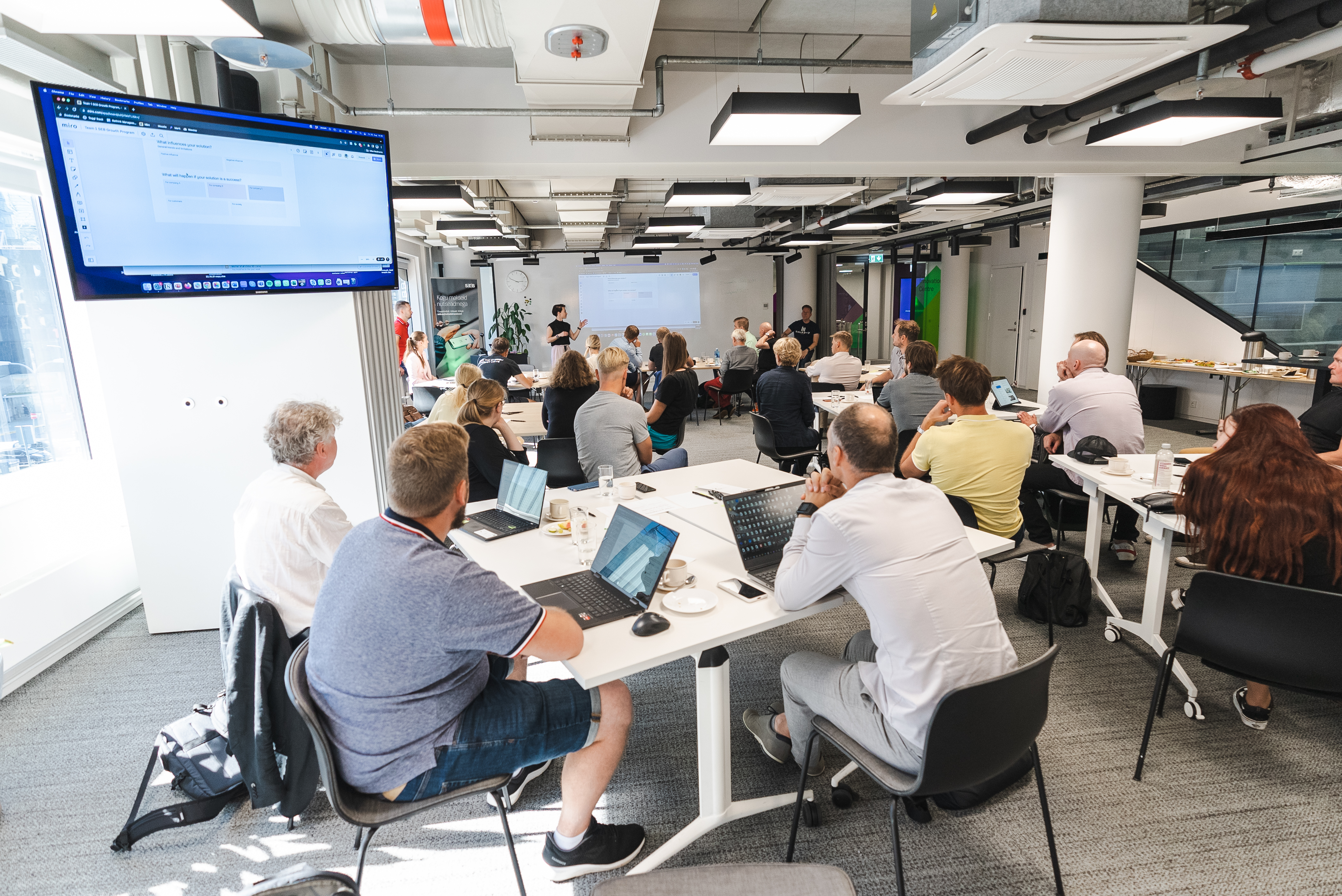 A full workshop room of SEB growth-program participants at laptops