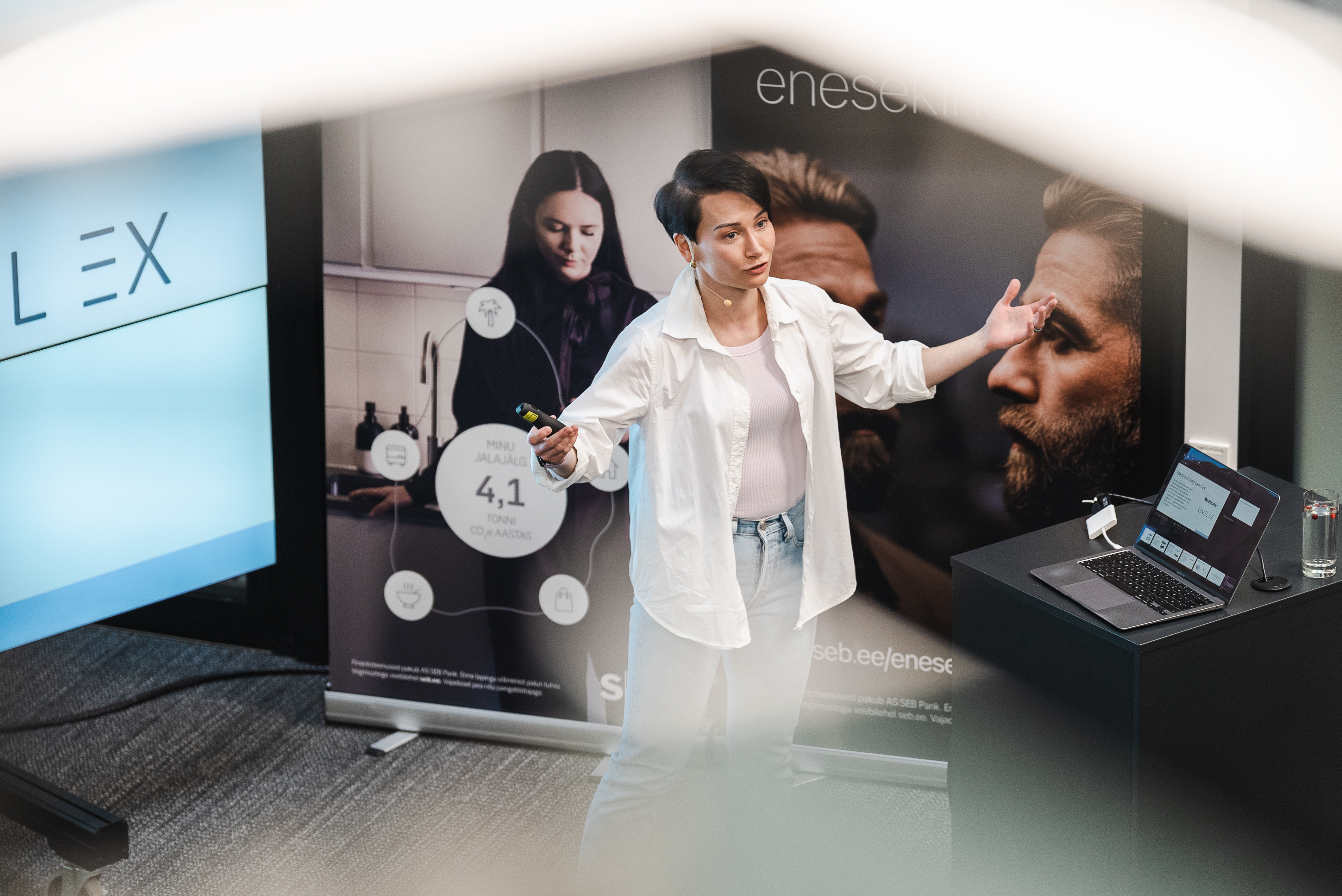 A speaker presenting in front of an SEB display wall