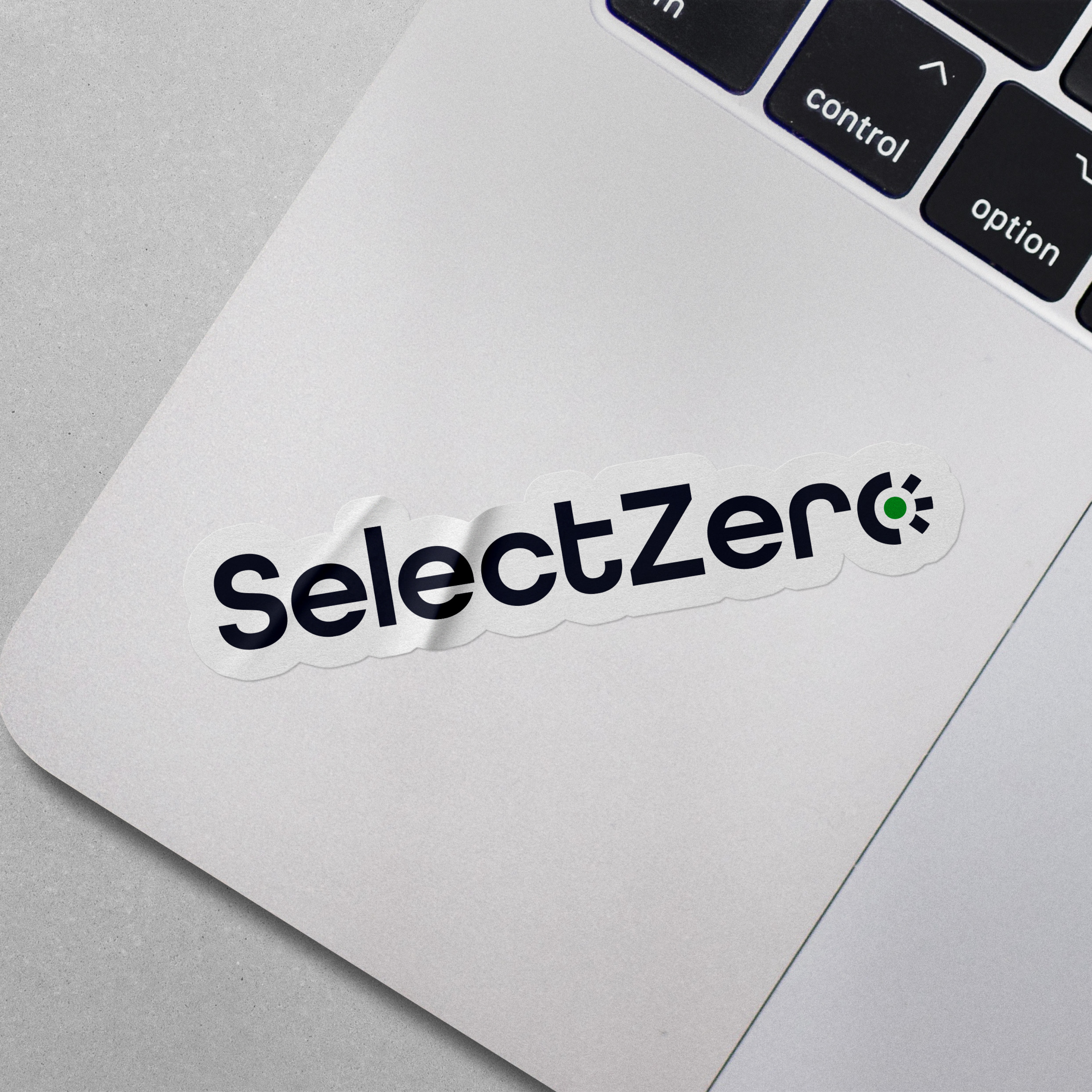 A SelectZero die-cut logo sticker on a laptop